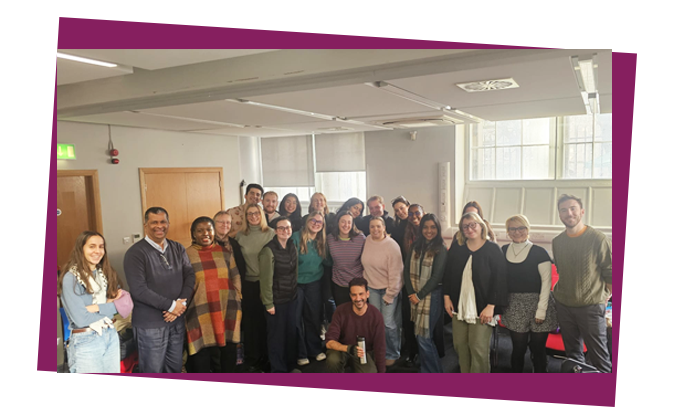A large group of people smile at the camera.