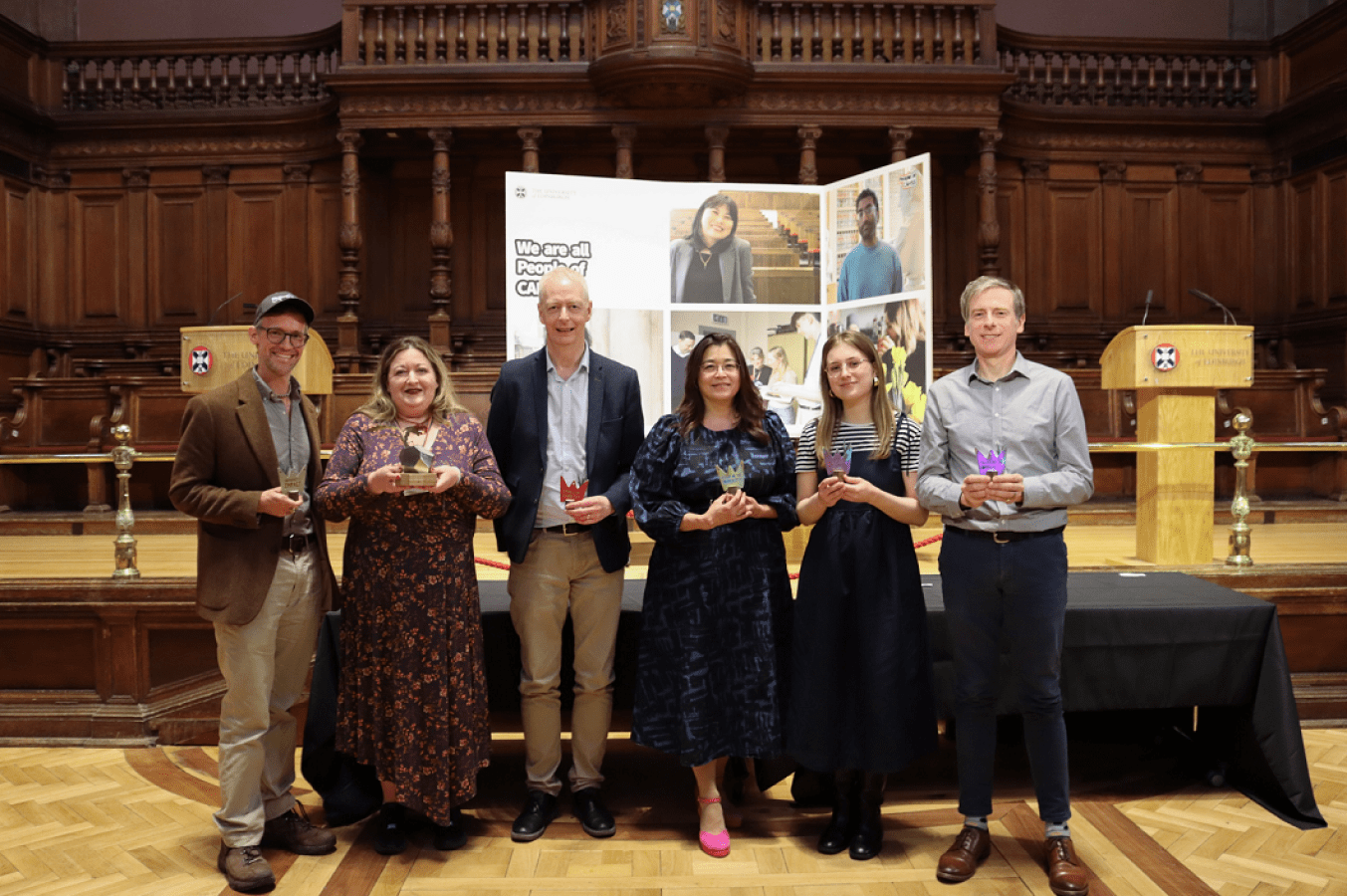 The six SPS People of CAHSS Award winners holding their prizes and smiling at the camera.