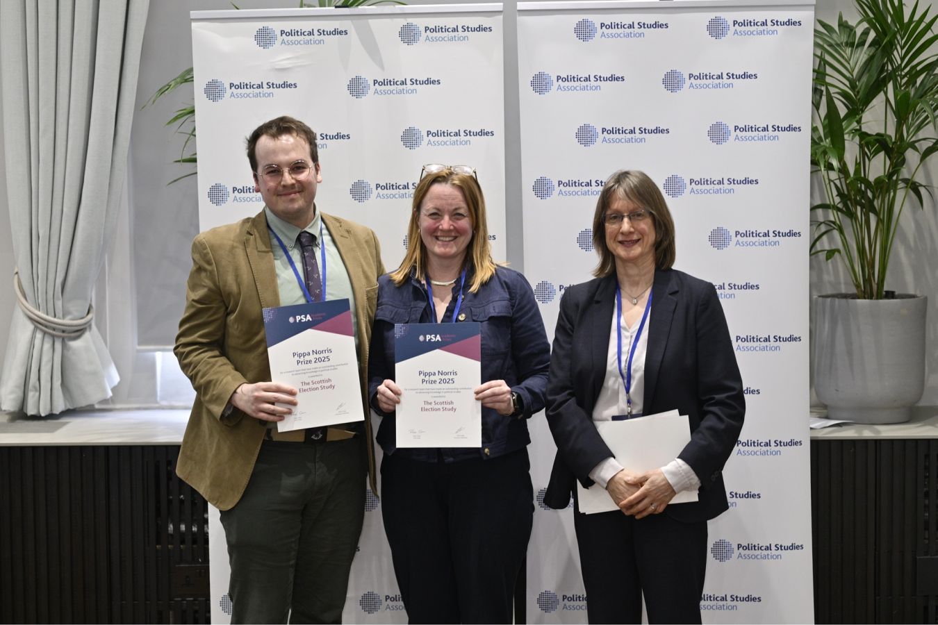 The Scottish Election Study team holding their prize certificates and smiling into the camera