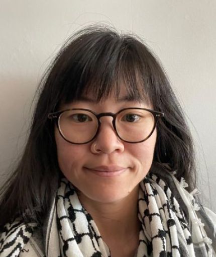 photo of a person with glasses wearing a kuffiyeh