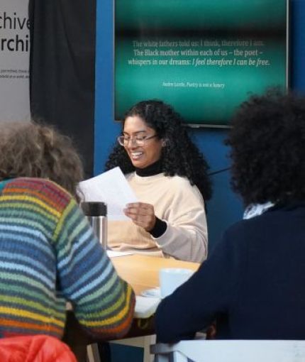 Chrisyl is photographed presenting a talk to some people