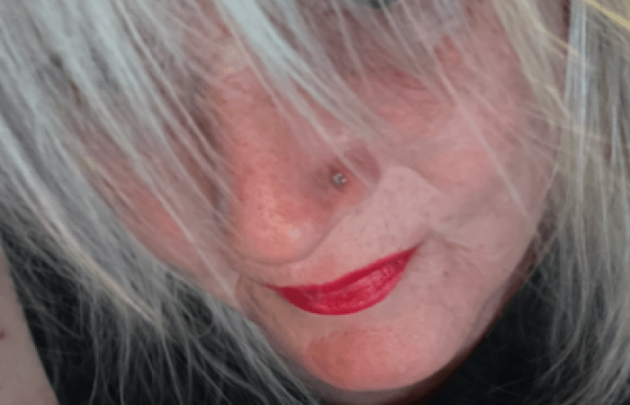 A picture of Alison staring upwards through her fringe