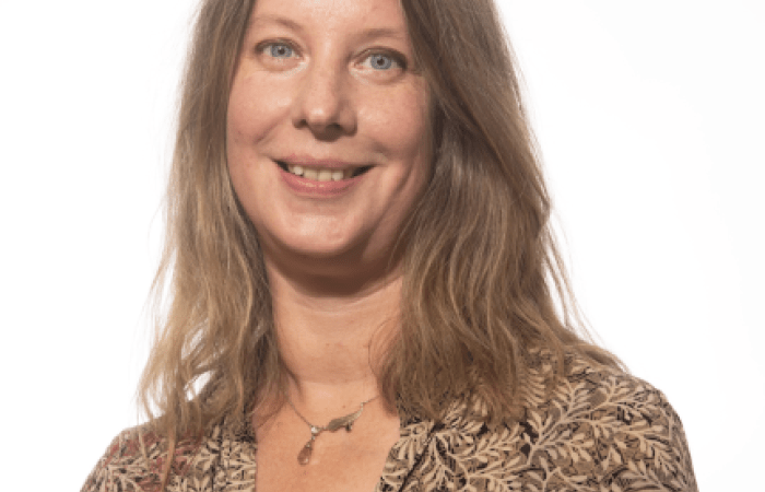 Picture of Niki, woman with half long hair, smiling