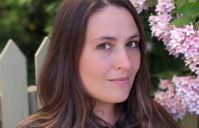 A portrait of Jamie surrounded by cherry blossoms. 