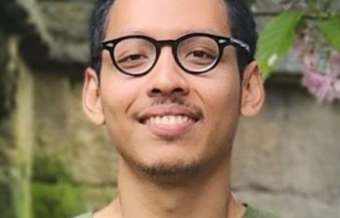 Man with glasses in green t-shirt