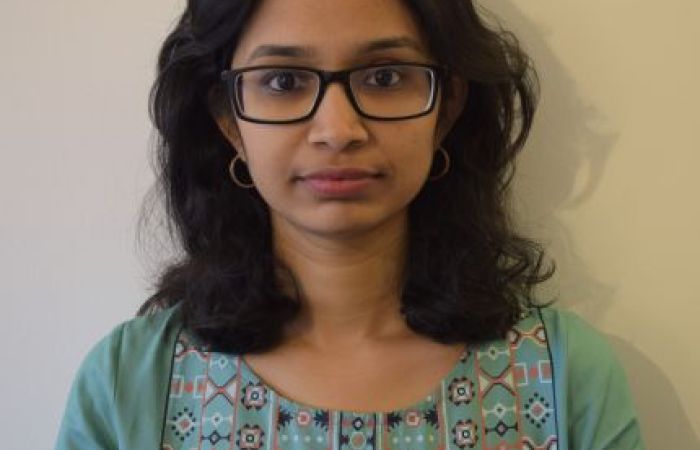 Picture of Srravya Chandhiramowuli which shows a woman of South Asian heritage, shoulder-length black hair, and wearing rectangular spectacles.